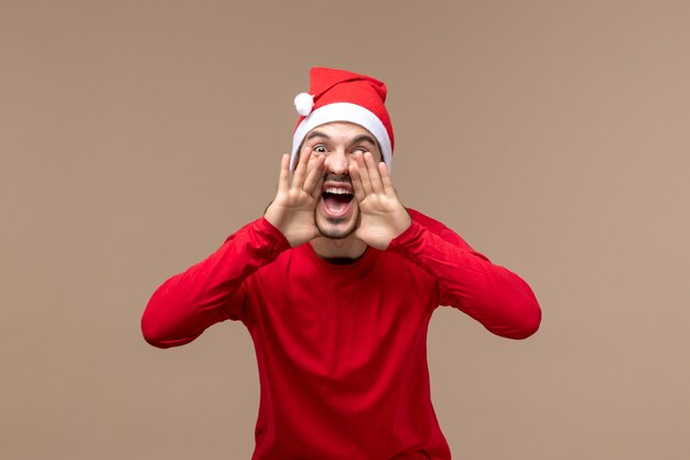 Front view young male screaming on brown background emotion holiday male