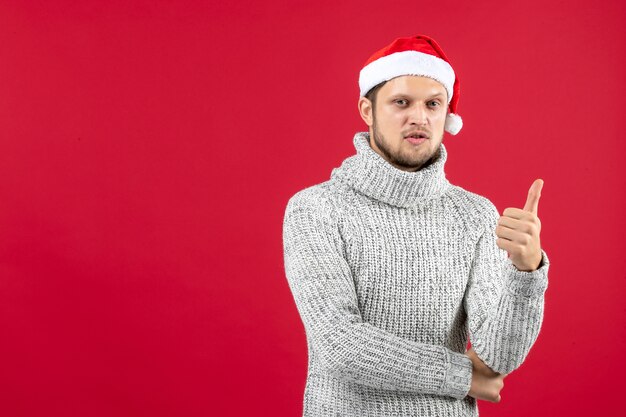 Front view young male in warm jersey on a red wall