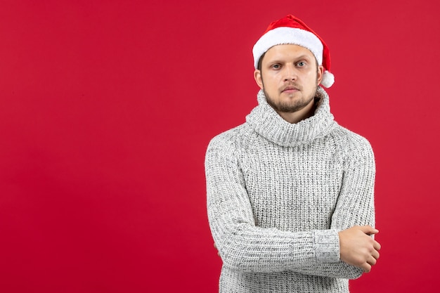 Front view young male in warm jersey on red wall