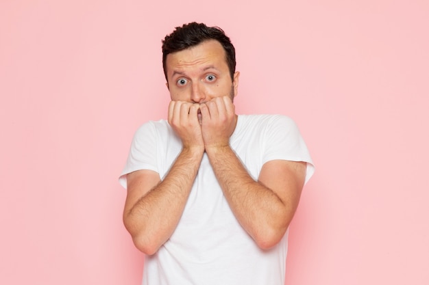 Free photo a front view young male in white t-shirt posing with scared expression