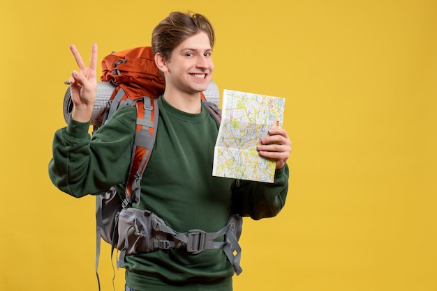 Free photo front view young male with backpack holding map