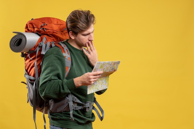 Free photo front view young male with backpack holding map