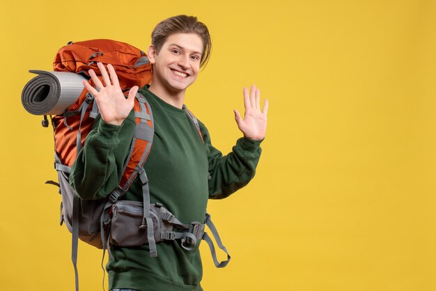 Front view young male with backpack preparing for hiking