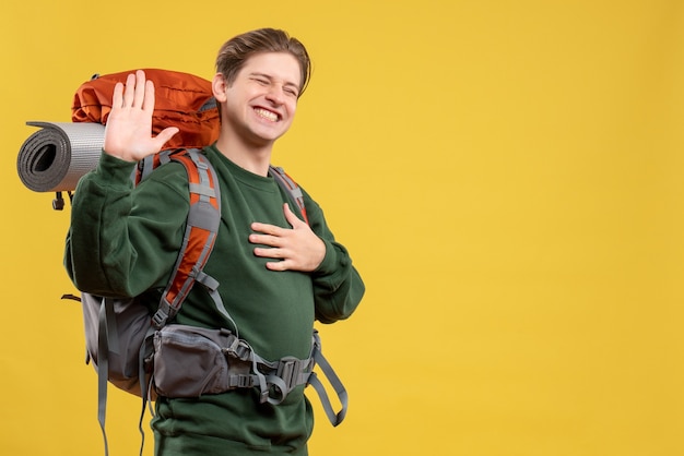 Front view young male with backpack preparing for hiking