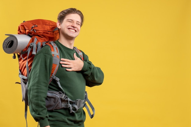 Front view young male with backpack preparing for hiking