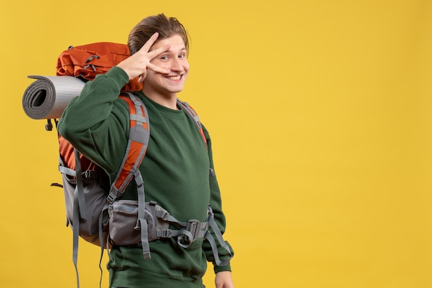 Front view young male with backpack preparing for hiking