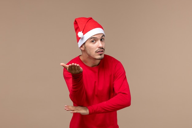 Front view young male with confused face on brown background christmas emotion holiday male