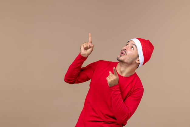 Front view young male with excited expression on a brown background emotion christmas holiday