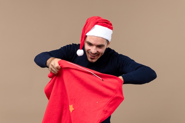 Free Photo front view young male with excited expression on brown floor christmas holiday santa