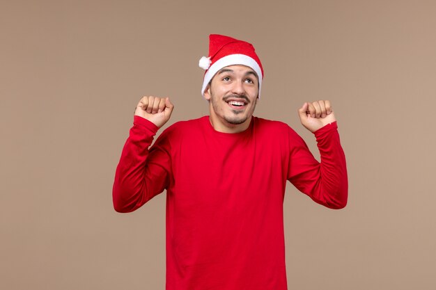 Front view young male with excited face on brown background christmas emotions holiday male