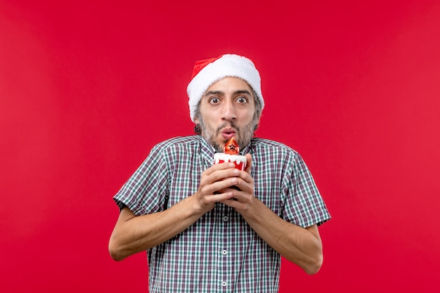 Free Photo front view of young male with little toy on red