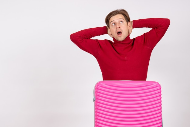 Front view young male with pink bag on a white background