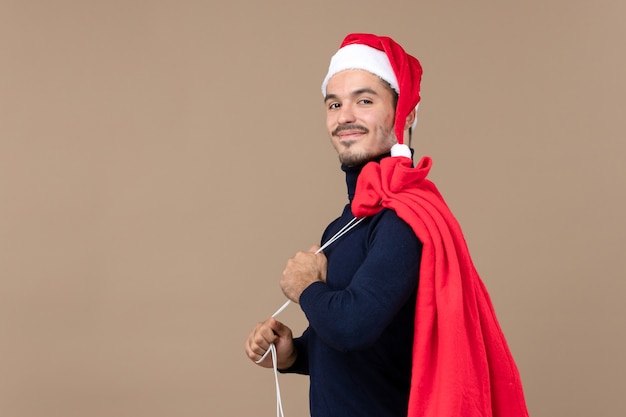 Free photo front view young male with red present bag, christmas holiday emotion