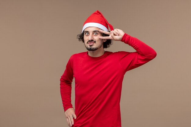 Front view young male with smiling expression on brown background christmas emotion holiday