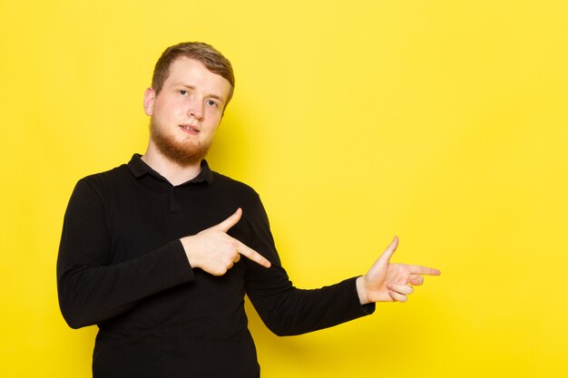 Front view of young man in black shirt posing