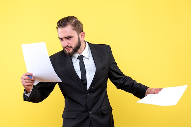 Free photo front view of young man businessman quickly checking each document on yellow