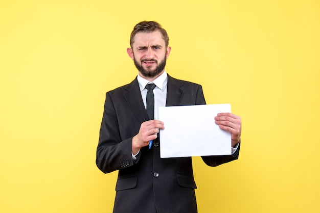 Free photo front view of young man businessman in a suit is bewildered he strictly  makes a questioning on yellow