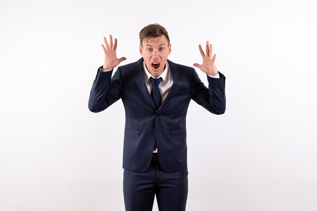 Front view young man in elegant classic suit screaming on white background