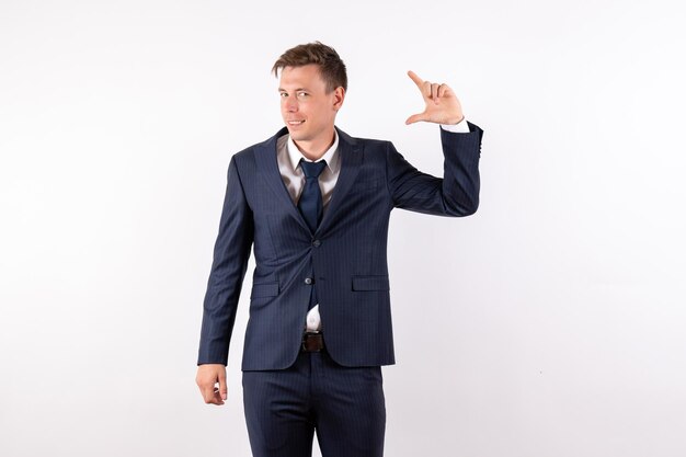 Front view young man in elegant classic suit smiling on white background