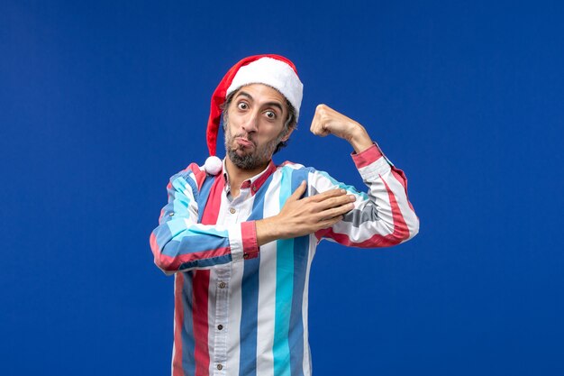 Free Photo front view young man flexing with excited face, emotions holiday male