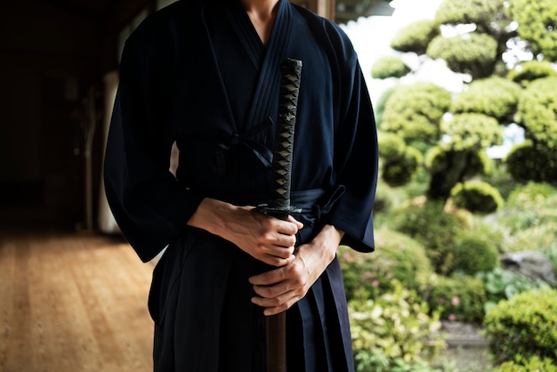 Front view young man holding sword