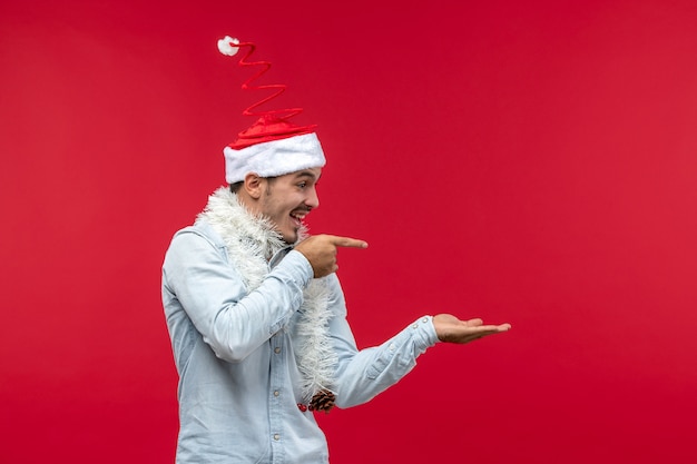 Free photo front view of young man just standing on red wall