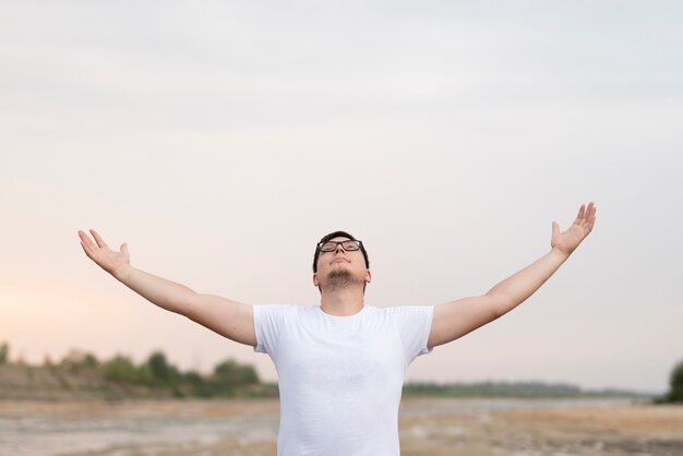 Front view of young man looking at the sky