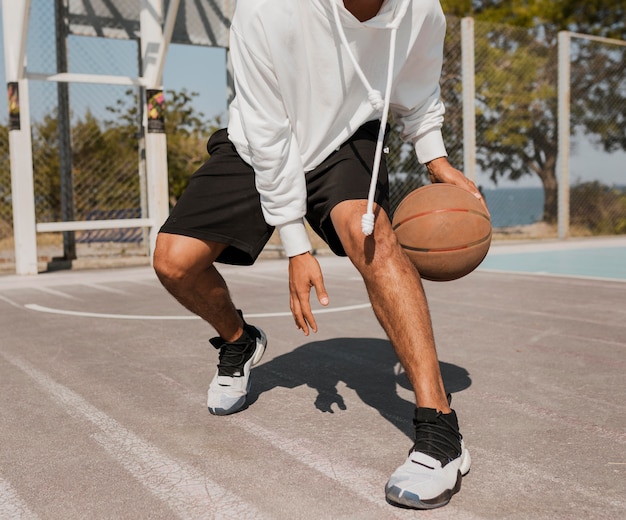 Front view young man playing basketball