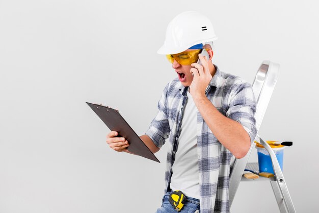 Front view of young man talking at phone