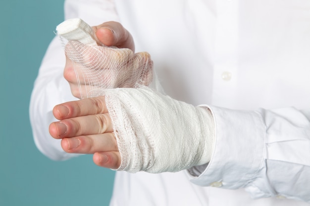 Free photo a front view young man wearing sterile bandage in white medical suit