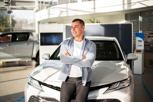 Front view young man with his new car