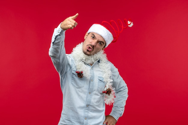 Free Photo front view of young man with nervous expression on red wall