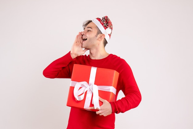 Front view young man with santa hat calling someone on white background