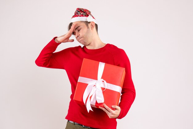 Front view young man with santa hat standing on white background free space