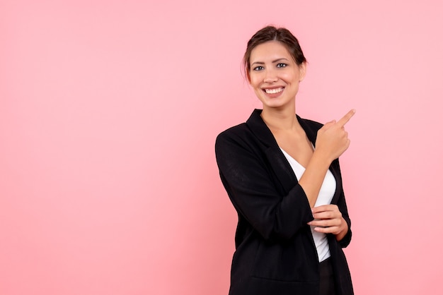 Free photo front view young pretty female in dark jacket on a pink background