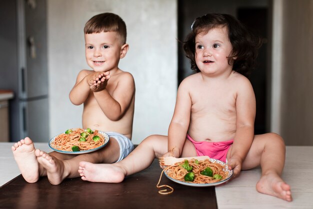 Front view young siblings in the kitchen