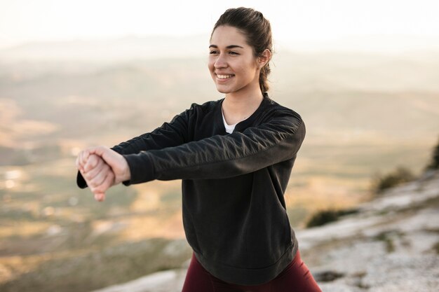 Front view young and smiley woman training