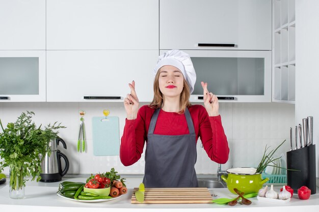 Front view young woman in apron making good luck sign