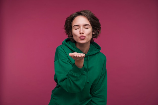 Free photo front view of a young woman blowing a kiss