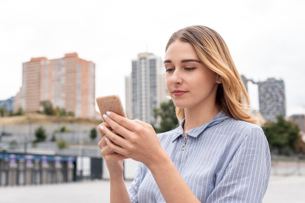 Front view young woman checking her phone