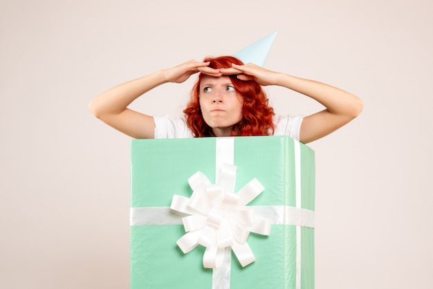 Free photo front view young woman inside present on the white background