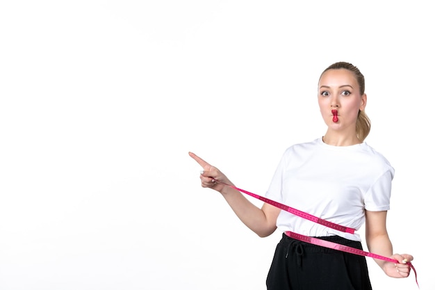 Front view young woman measuring her waist on white background beauty losing measuring torso skin waist hip scale