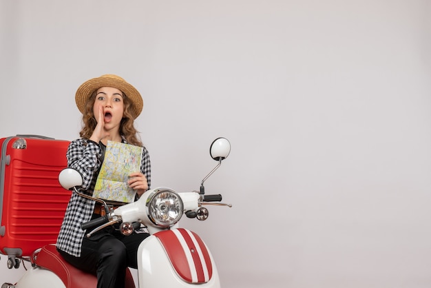 Front view young woman on moped holding map calling someone