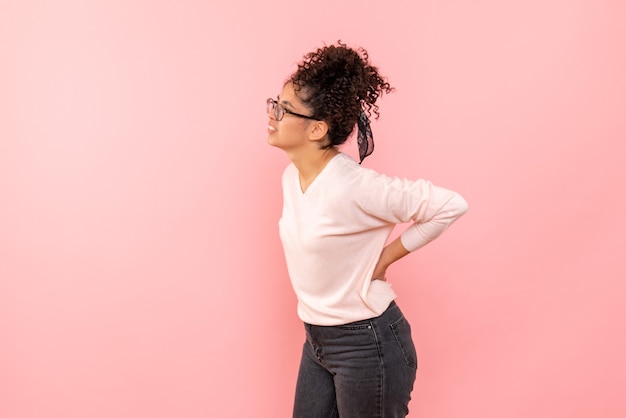 Free photo front view of young woman on pink wall