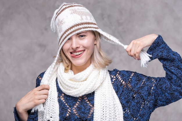 Free Photo front view young woman playing with hat