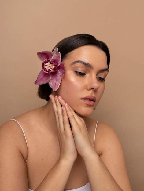 Free photo front view young woman posing with flower