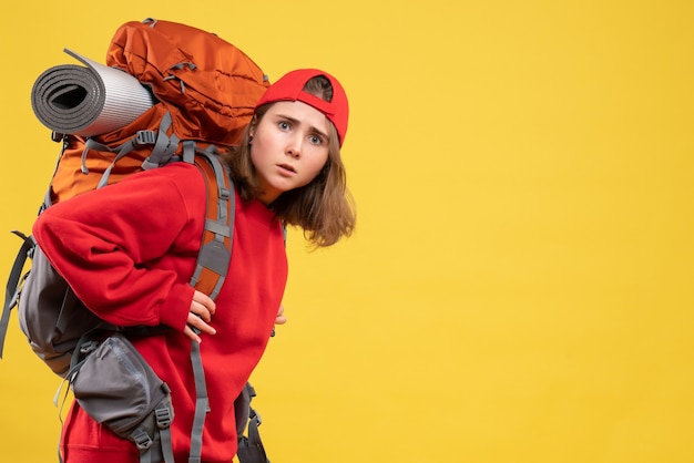 Free Photo front view young woman in red backpack standing on yellow wall