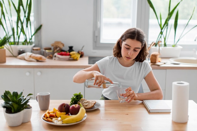 Front view young woman relaxing in the kitchen