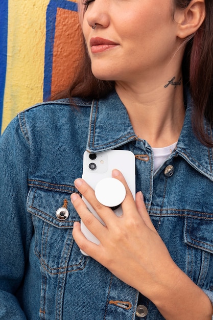 Front view young woman using popsocket