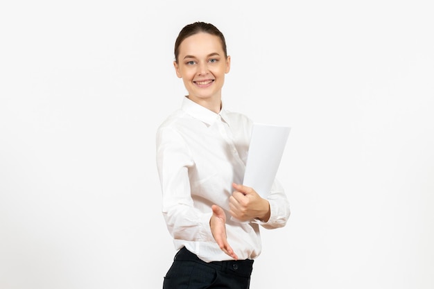 Front view young woman in white blouse holding documents and smiling on white background female emotions feeling office job